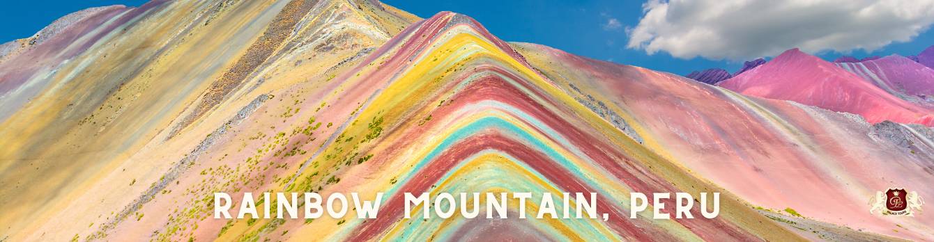 Rainbow Mountain (Vinicunca) in Peru, featuring vibrant layers of yellow, red, turquoise, and pink. Part of the Best of Peru tour.